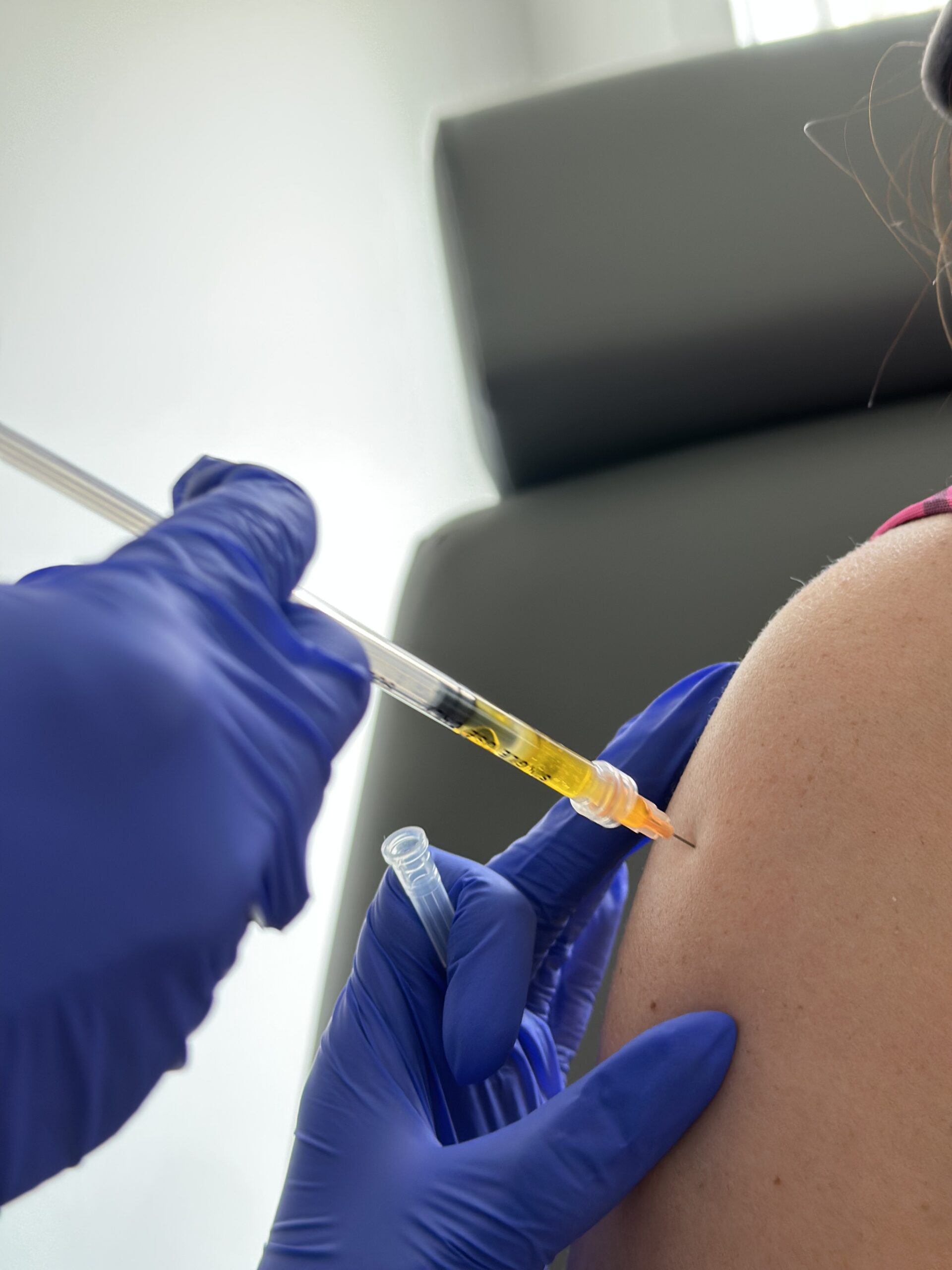 Syringe going into shoulder