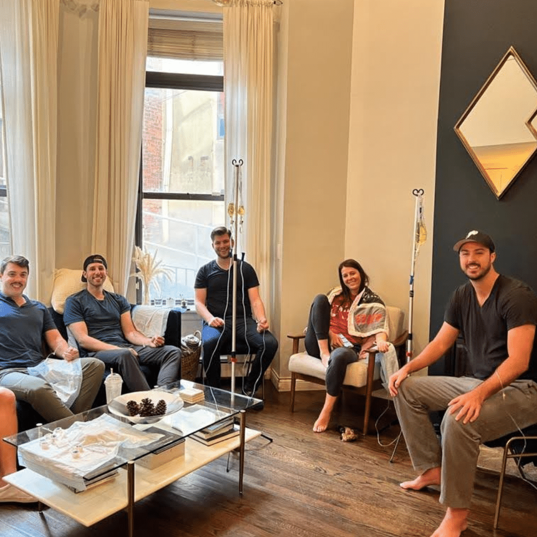 Group of 5 adults receiving IV therapy treatment