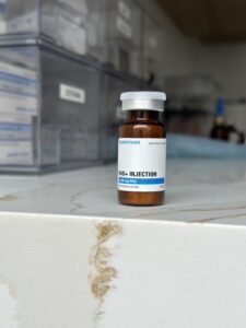 NAD booster vial on marble counter. 