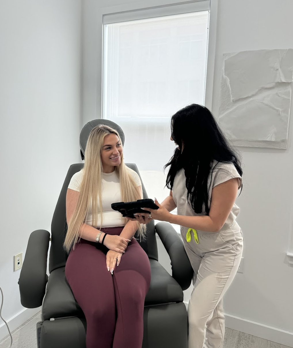 A nurse showing a patient her results on an electronic tablet