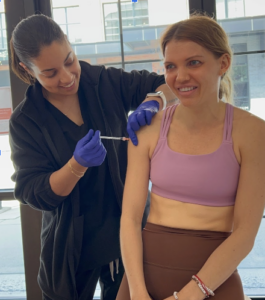 IV Elements certified nurse administering Vitamin D shot to client.