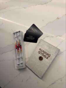 Image of vitamin shots alongside IV Elements business cards on a marble counter.