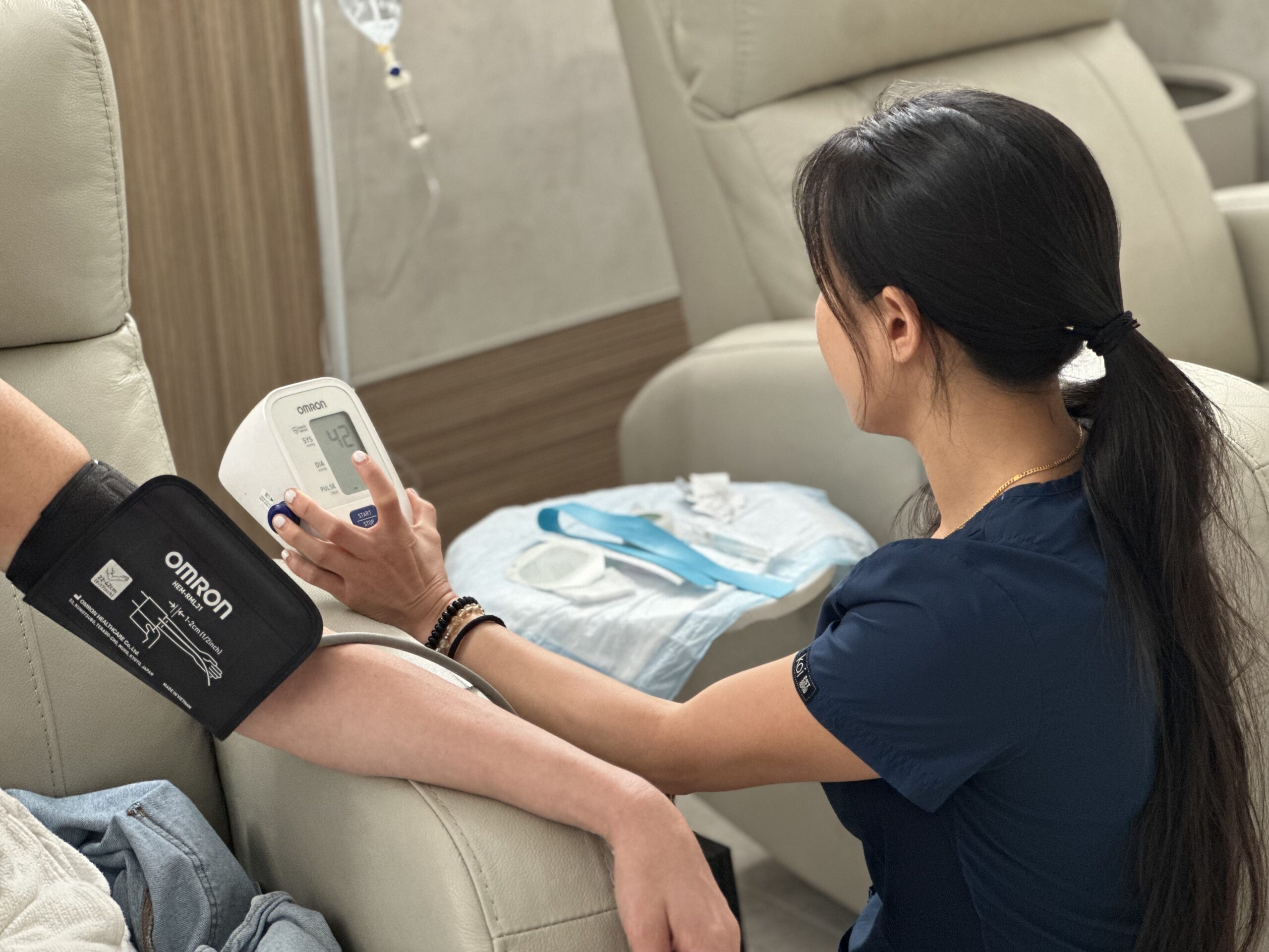 Nurse taking blood pressure from arm.