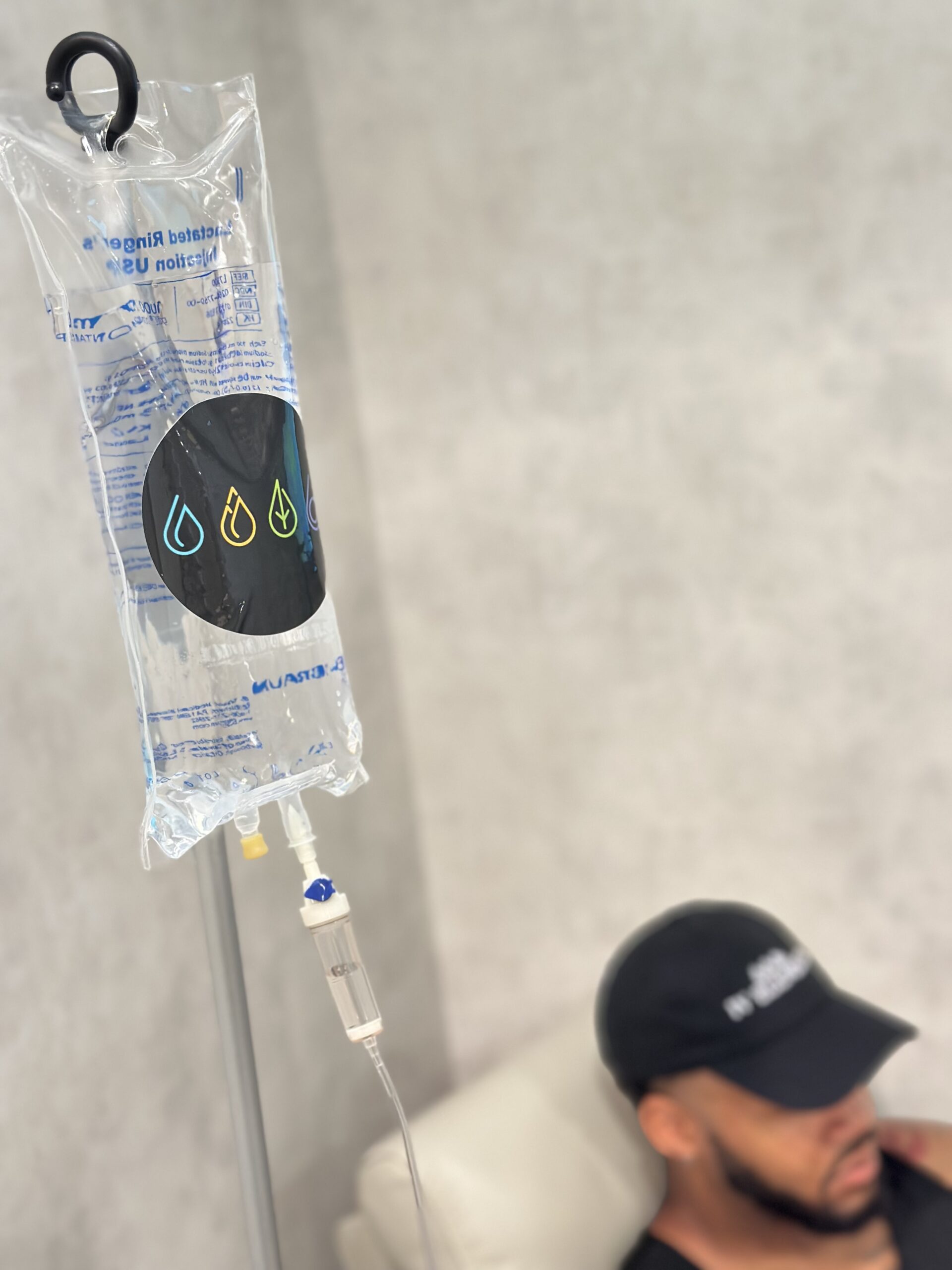 man sitting in chair receiving IV.