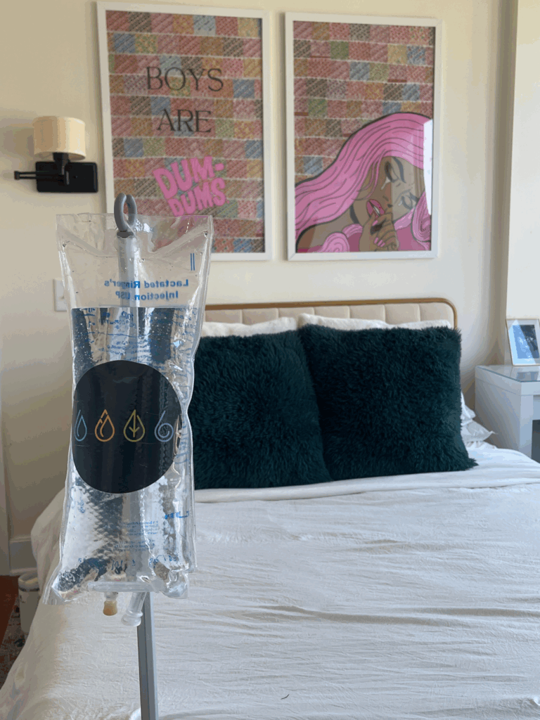 IV Bag with IV Elements logo on pole with bed in the background