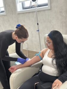 Nurse administering IV for patients iron infusion.