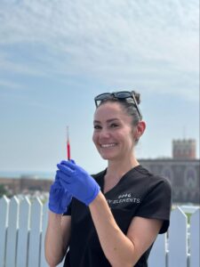 IV Elements nurse holding Vitamin D injection at NJ outdoor event.