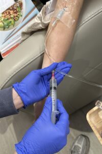 IV Elements nurse administering a glutathione push to clients IV. 